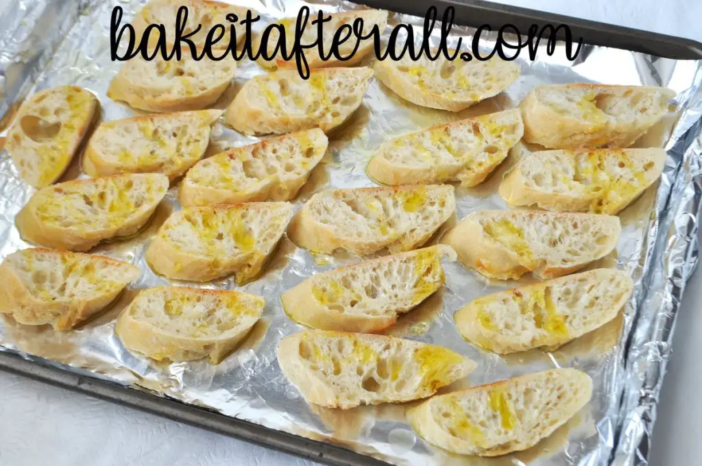 sheet pan with slices of baguette covered in olive oil