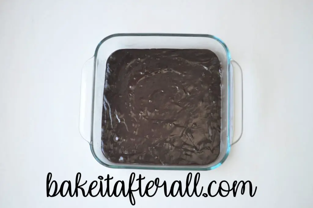 brownie batter in a square baking dish 