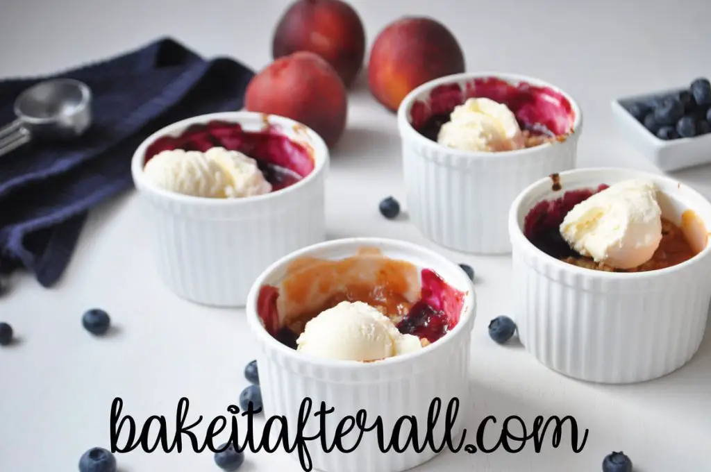 Peach Blueberry crumbles with vanilla ice cream on top