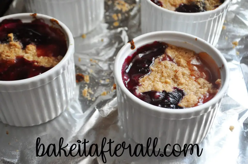 peach blueberry crumbles in ramekins after baking