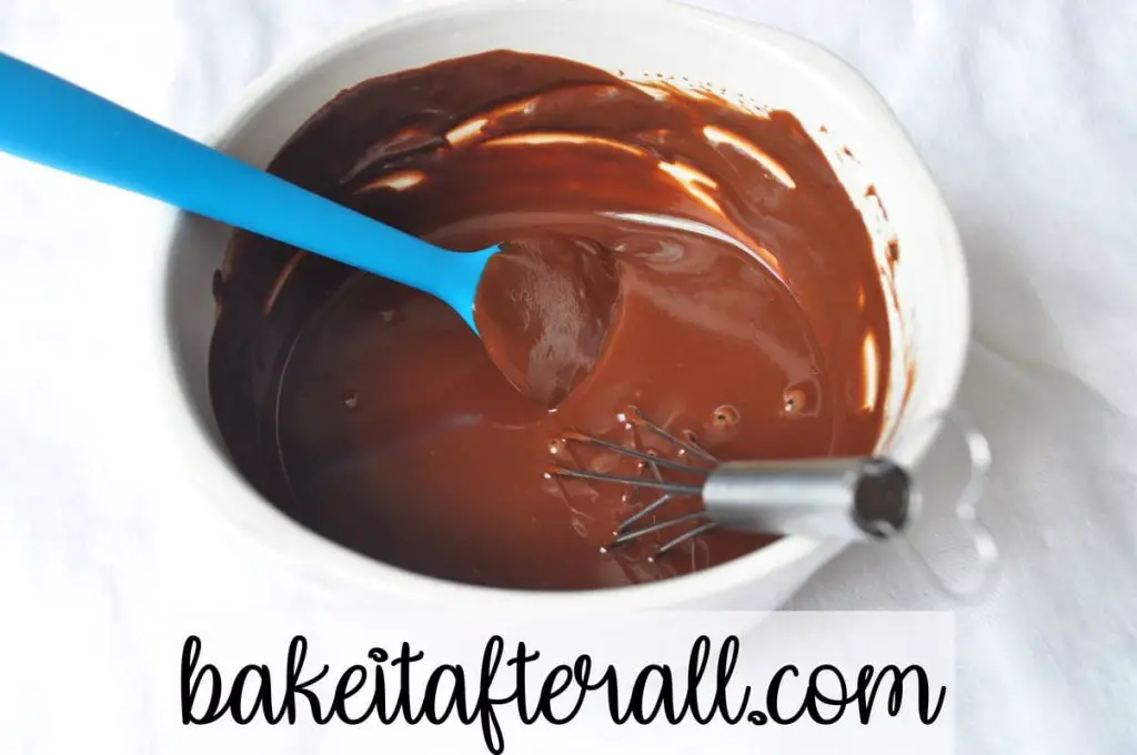 bowl of ganache with a whisk and silicone spatula