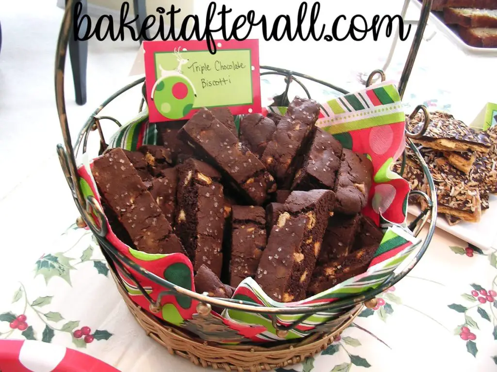 triple chocolate biscotti in a holiday basket on a holiday dessert table