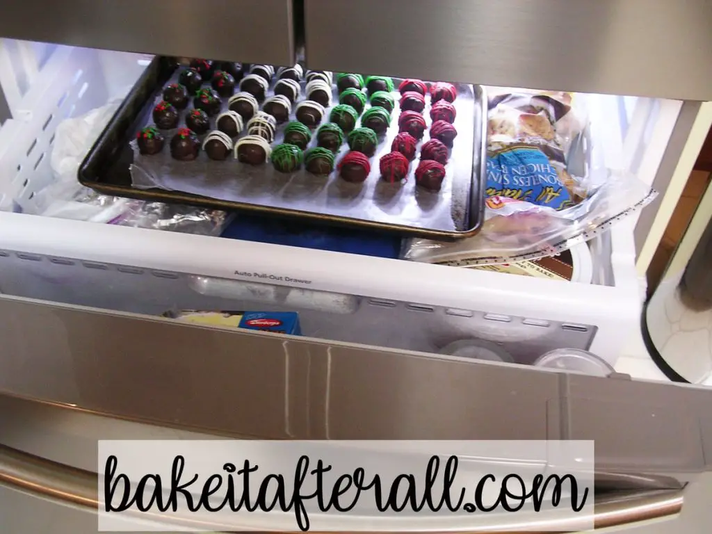 freezer drawer open containing a tray of homemade oreo truffles