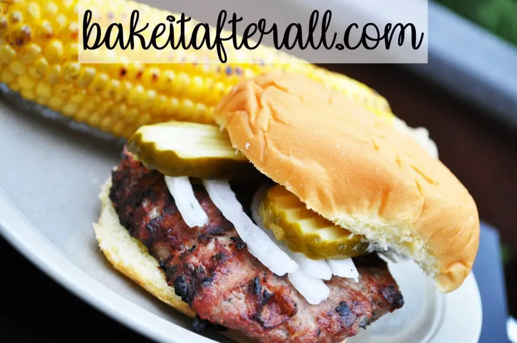turkey burgers on a plate with corn on the cob
