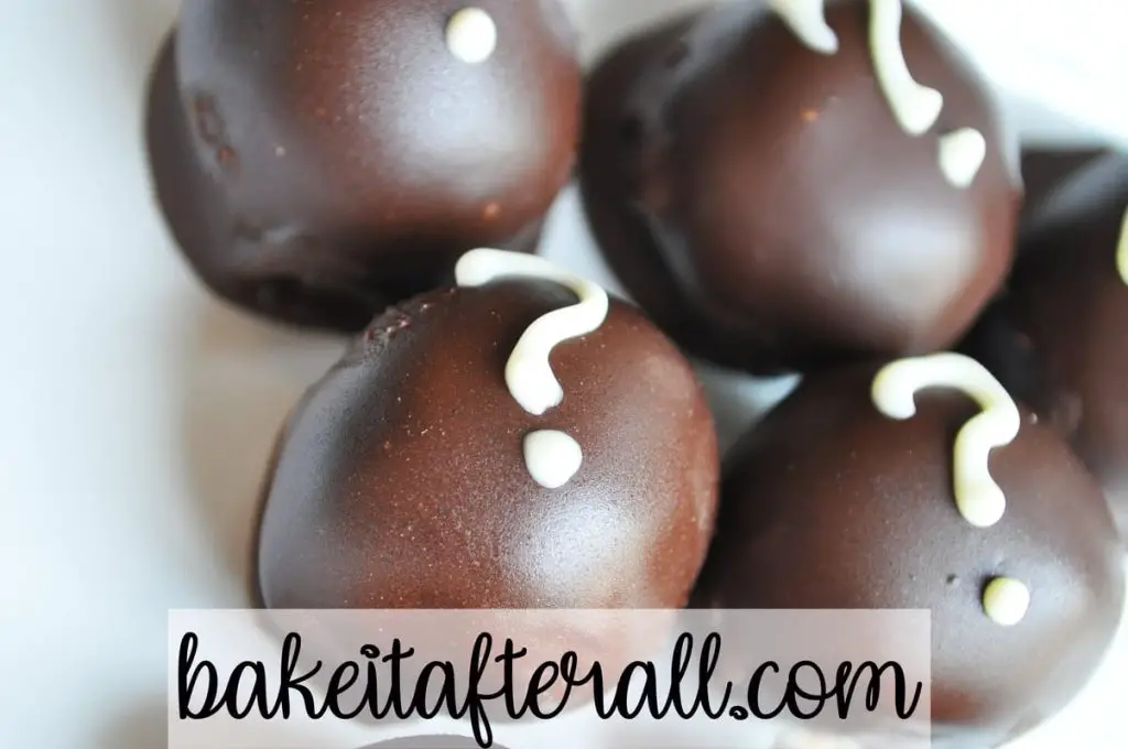 oreo truffles covered in dark chocolate with white chocolate question marks on top