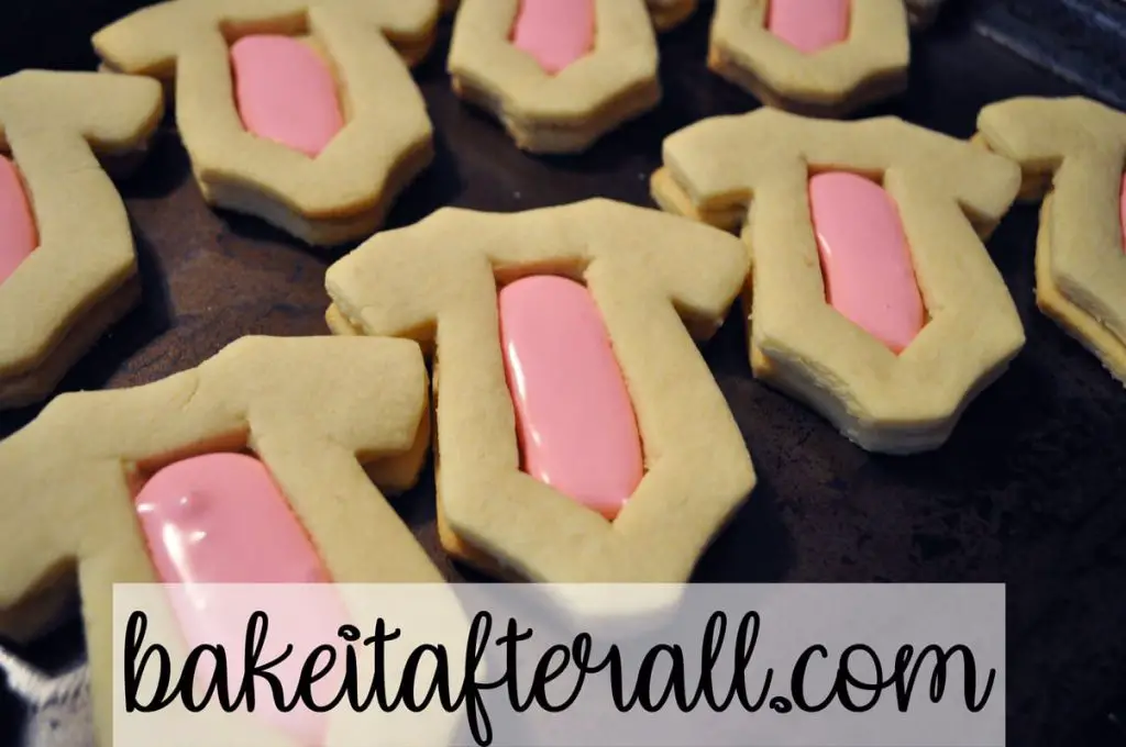 bottom and middle cookies together filled with pink royal icing in the center cavity