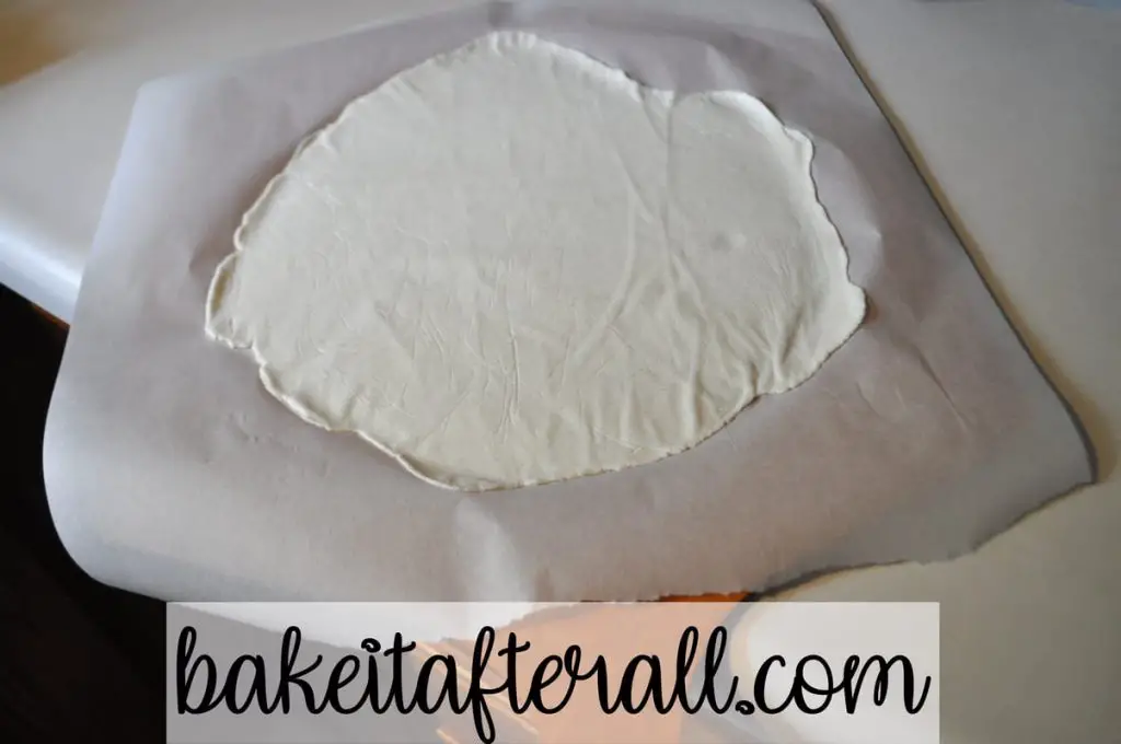 pizza dough ready for oven on pizza peel