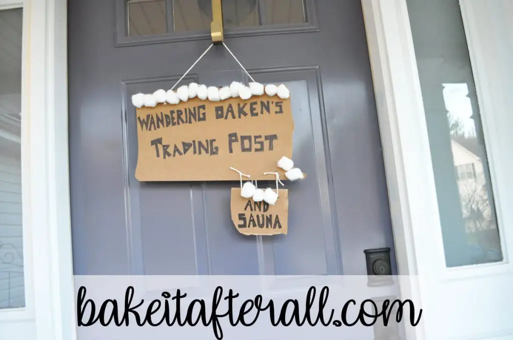 Wandering Oaken's Trading Post and Sauna cardboard sign hanging on front door