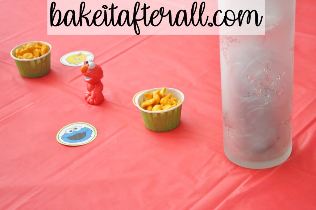 Sesame Street Birthday Party with Elmo figure and candy cups of goldfish crackers