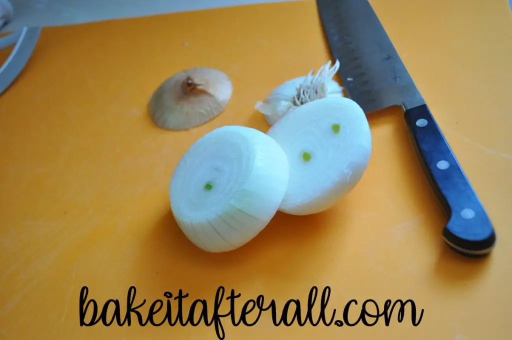 onion slices and knife on a cutting board