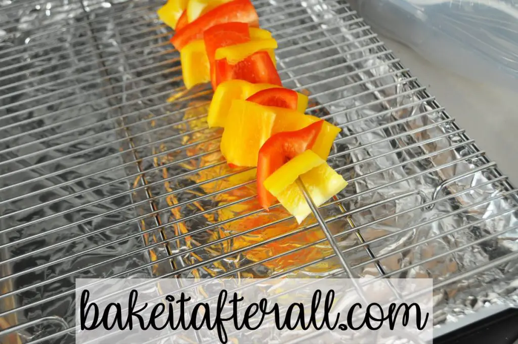 yellow and red pepper pieces on a metal skewer