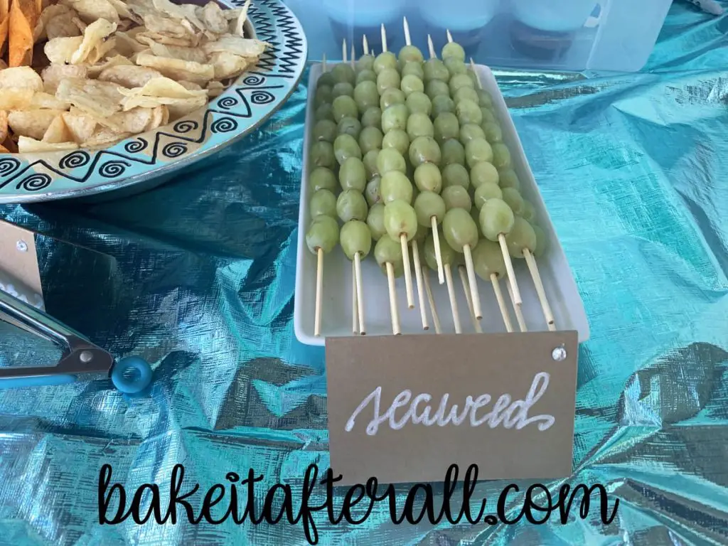 green grapes on wooden skewers labeled "seaweed"