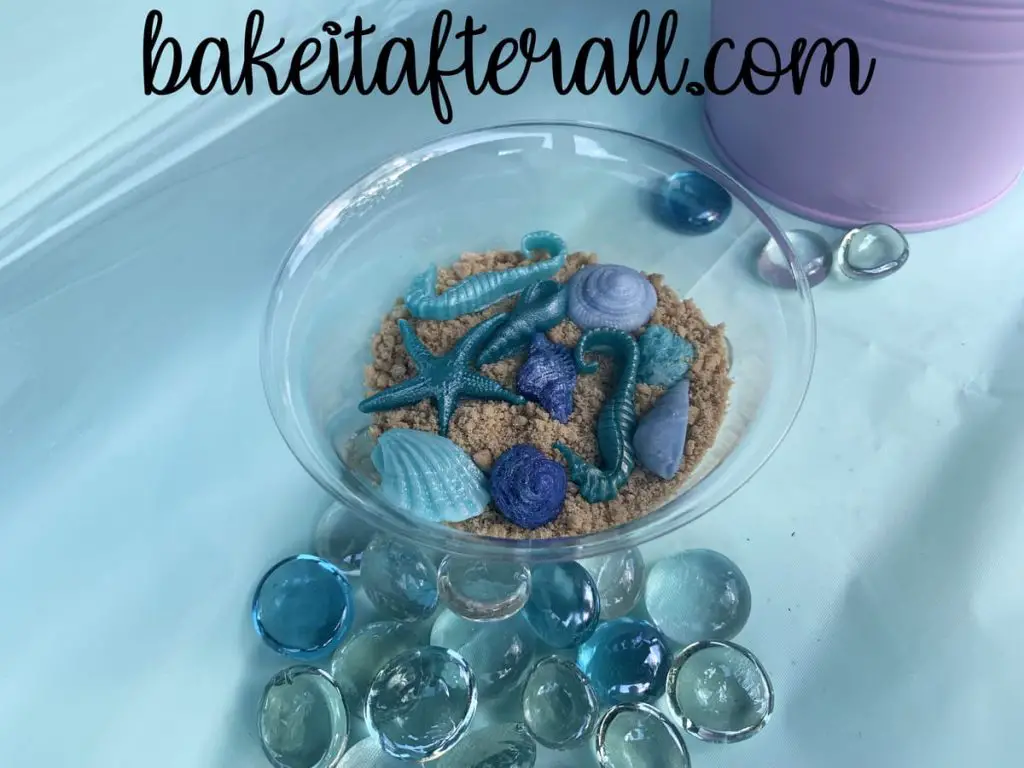 bowl with fondant shells and seahorses in crushed graham crackers to look like sand