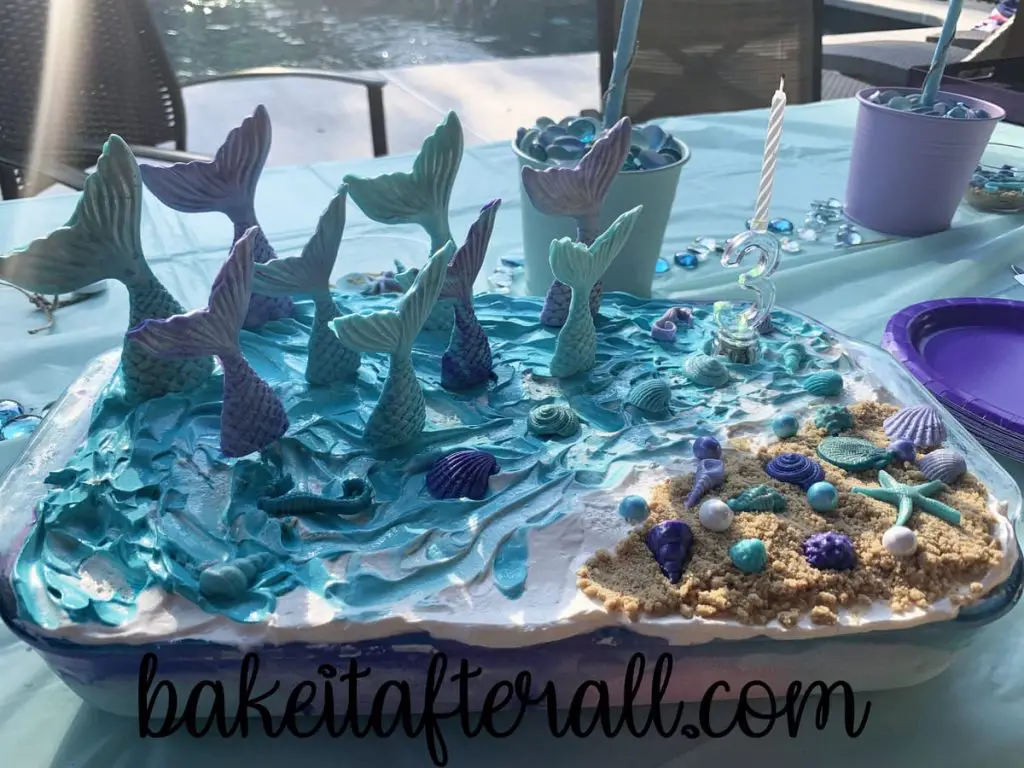 Mermaid Birthday Cake on a table by a pool