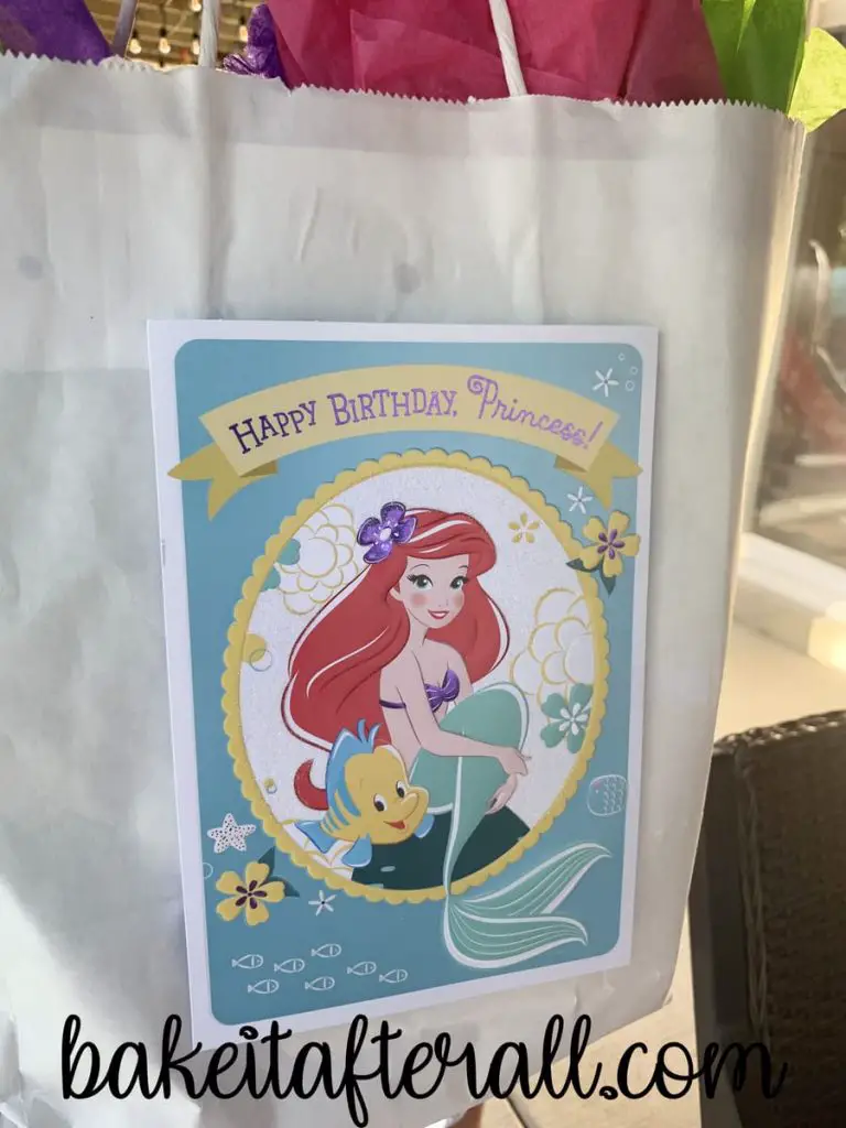 birthday gift with a card that says "happy birthday princess" with the little mermaid on it
