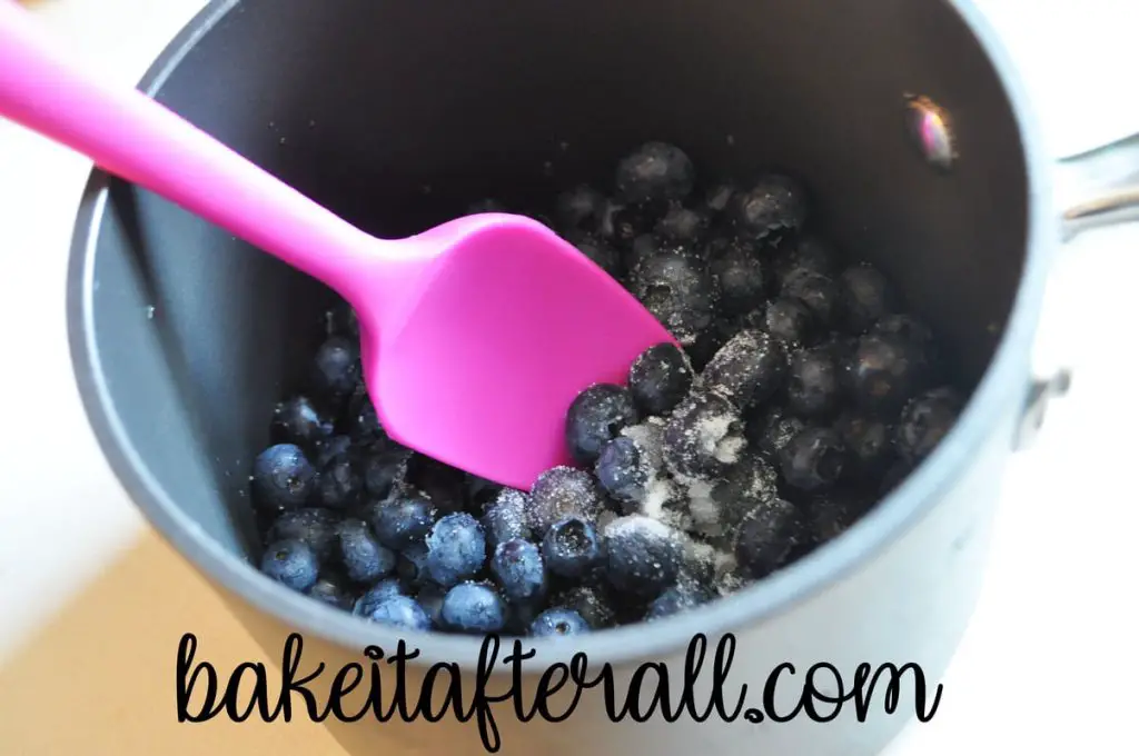 Blueberries and sugar in a saucpan