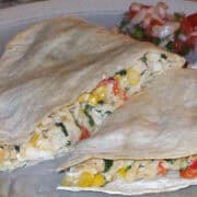 baked quesadillas with creamy cilantro jalapeno sauce on a plate with pico de gallo on the side