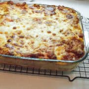 a glass dish of five veggie four cheese lasagna