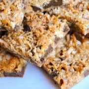 Seven Layer Bars stacked up on a white plate