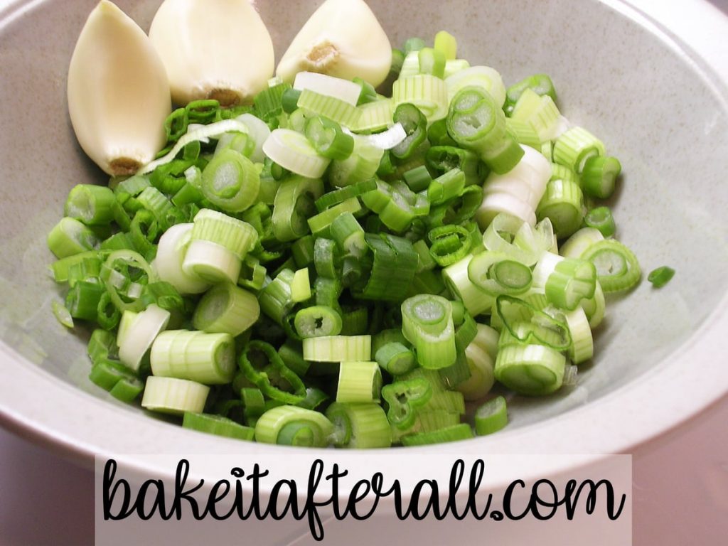 chopped green onions and garlic in a bowl