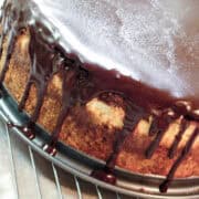 a Bailey's Irish Cream Cheesecake on a springform pan base on top of a cooling rack