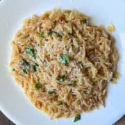 a plate of orzo with parmesan and basil