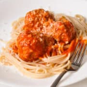 a plate of spaghetti with turkey meatballs on top