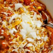 turkey pumpkin chili in a bowl with a metal spoon in it