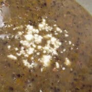black bean soup in a bowl with feta cheese on top