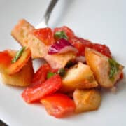 a pile of panzanella on a white plate