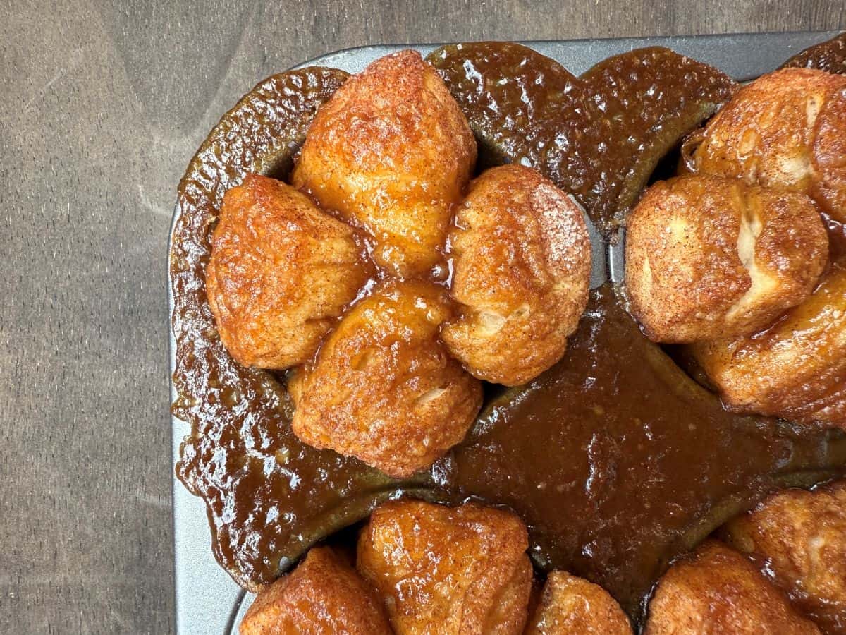 a close up of a monkey bread muffin still in a muffin pan