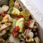 chicken and vegetable bake in an off-white casserole dish