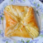 a blueberry cheese Danish on a flowered China plate
