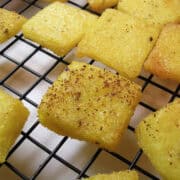 Garlic Parmesan Polenta Croutons on a wire cooling rack