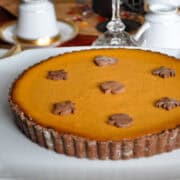 pumpkin chocolate tart on a white cake plate