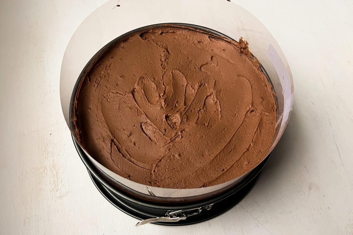 Godiva chocolate cheesecake with mousse inside and an acetate collar