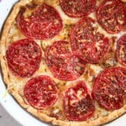 simple tomato tart in a white pie dish
