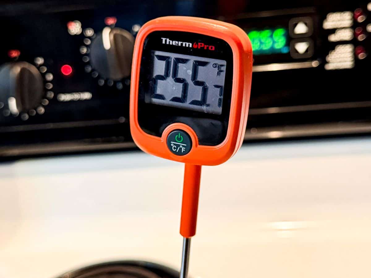 a digital candy thermometer registering 255 degrees Fahrenheit