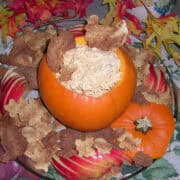 fluffy pumpkin dip in a hollowed out pumpkin with cinnamon sugar tortillas