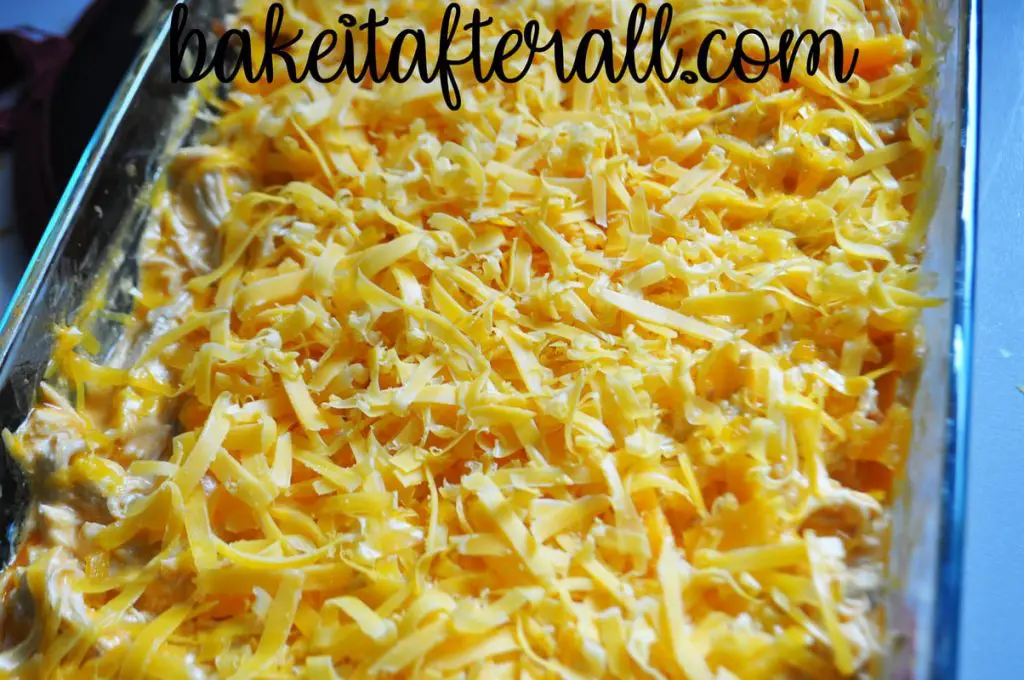 dip after being stirred with shredded cheddar cheese on top