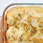a glass casserole dish of potatoes and onions
