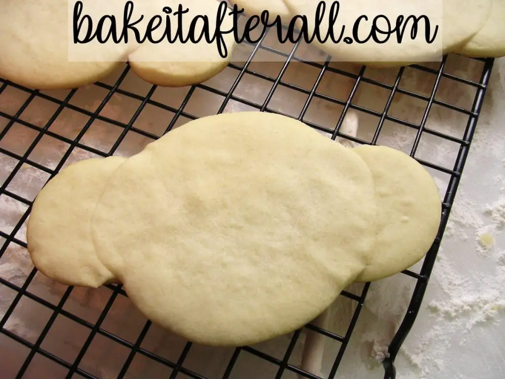 baked sugar cookie shaped like a monkey face on a cooling rack