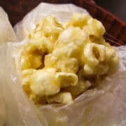a Caramel Popcorn Ball with waxed paper around it