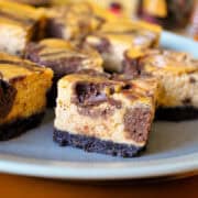chocolate pumpkin cheesecake bars on a plate