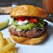 a guacamole turkey burger on a white plate