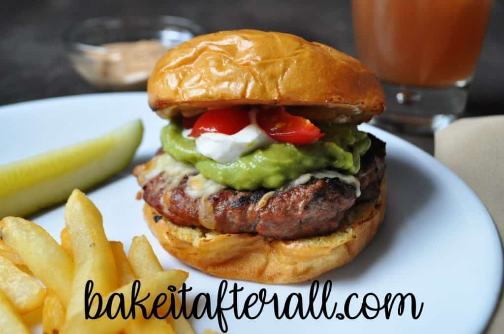 Guacamole Turkey Burgers on a white plate with friess