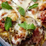 eggplant parmesan in a casserole dish with fresh basil on top