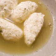 a bowl of ricotta gnudi in a parmesan broth