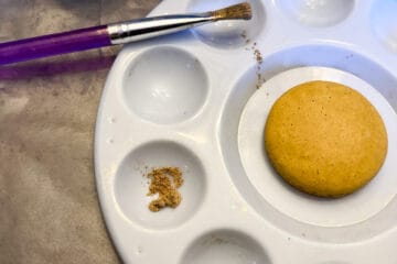 gold powder in the well of a paint palette