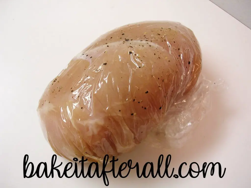 stuffed chicken wrapped up in plastic wrap bundles